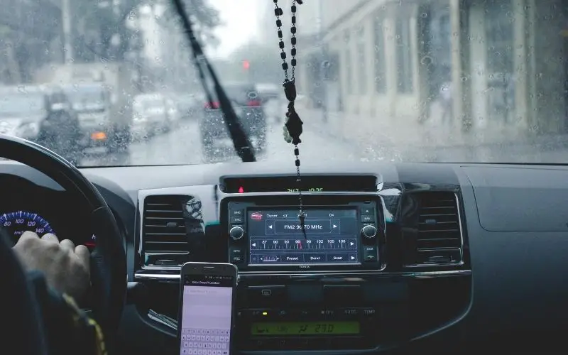 Person driving a car while raining