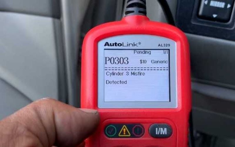 an OBD scanner with P0303 code on the screen