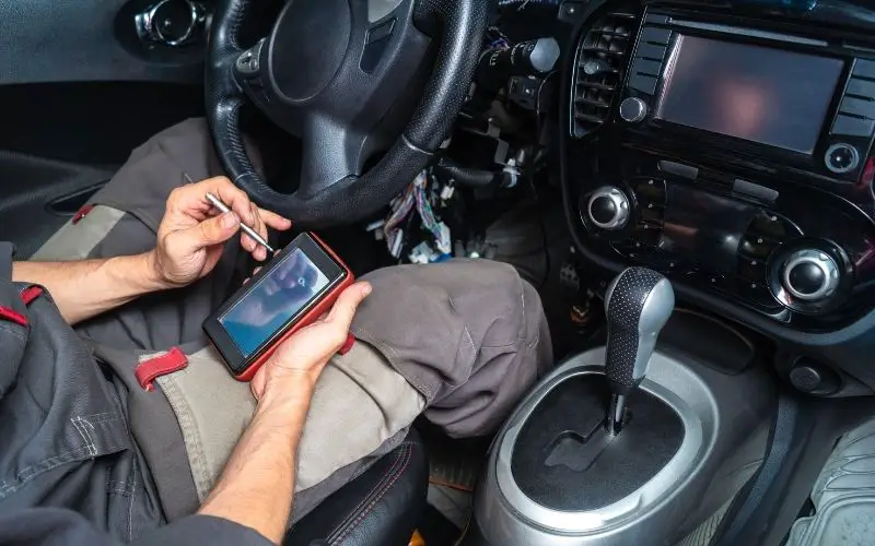 a driver checking OBD codes on his car